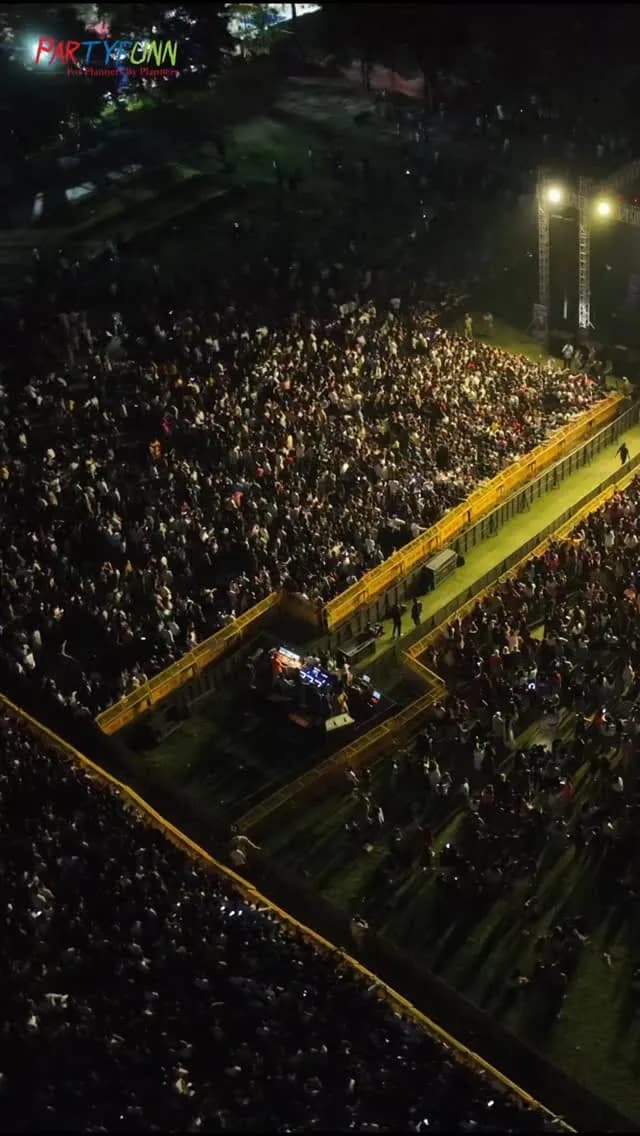 Thousands of fans filling a stadium at night